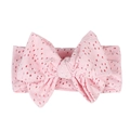 Pink hollow lace baby headband with a large knotted bow on a plain white background - Pink