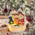 Nahaufnahme eines beleuchteten Weihnachtshauses aus Harz mit Weihnachtsmann und LED-Licht - Weihnachtsmann Stil B