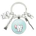 Silver metal keychain with dentist charms including floss, toothpaste, and toothache art - Popsicle Toothache Illustration (27)