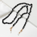 Detailed macro of marble acrylic chain link with golden lobster clasps and silicone loops - Black+White