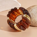 Detail of tortoiseshell resin blocks and gold metal spacers on a wide elastic bracelet - Brown