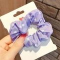 Detail of purple polka dot scrunchie made of elastic fabric on a display card - Purple Polka Dot