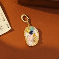 Vintage gold oval pendant with enamel flowers, honeybee, and crystal border decoration - Pearlescent Off-White Bee and Floral Style
