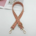Detail view of colorful wavy woven replacement bag strap with golden metal swivel hooks - White Orange Brown + Gold Hook