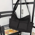 Versatile black canvas messenger bag with large front pockets and adjustable strap - Black