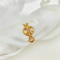 Vintage golden eight-pointed star ring with pink gemstone and twisted band on white silk - Adjustable Open / Gold with Pink Zirconia