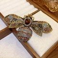 Detail view of a vintage gold bee brooch featuring colorful rhinestones and a brown gem center - Rhinestone Dragonfly Bee Wings Contrast (6#)