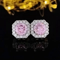Macro detail of pink zircon halo stud earrings with silver base on black reflective surface - Round Pink Style (E1104)