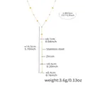 Detail view of gold Y-shaped necklace with heart and zircon charms on white background - Gold Heart Y-Shaped Zircon Necklace