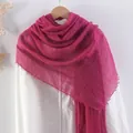 Solid magenta linen cotton scarf with pleated texture and frayed edges on a wooden hanger - Rose Red