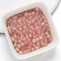 Pink and yellow crackle glass beads in a white bowl for DIY jewelry making - Pink Yellow Ice Crackle Lampwork Beads