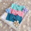 Three colorful nylon baby headbands with textured bows on daisy tulle background - Three-Piece Set / Mint Green, Pink, Navy Blue