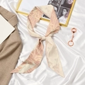 Beige French silk scarf with pastel patterns tied in a bow on white satin - Space Horse Pink Beige