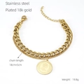 Detailed macro view of 18K gold plated double-layer chain bracelet with coin pendant - Gold