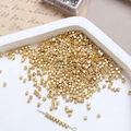 Macro shot of 14k gold-plated tiny cube beads for DIY jewelry making and bracelet crafts - 2mm 18k Gold (10 Pcs)