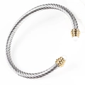 Detail of twisted cable steel bangle with gold accents and pearl inlay terminals - Two-tone-White Stone
