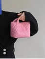 Close-up of pink woven leather texture on a mini bucket bag with a stylish handle - Peach Pink