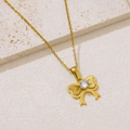 Close-up of golden bow-tie necklace with a sparkling round zircon on stone background - Matte Bow Knot with Zirconia (NKS-002_04)
