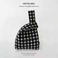 Knitted wrist bag with black and cream checkerboard pattern and soft vest handle - Black Polka Dot