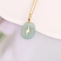 Macro shot of gold necklace with oval green stone pendant and lightning bolt inlay - Light Green Oval Lightning (13#)