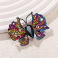 Elegant rainbow butterfly brooch with blue teardrop gemstone and crystal accents - Iridescent Butterfly Style