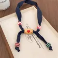 Handmade fabric necklace featuring dark blue denim cord and red heart wood bead charm - Blue