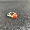 Detail view of handmade wire-wrapped ring with round orange-red carnelian stone - Adjustable Open / Red Agate