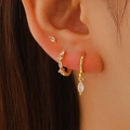 Three-piece gold plated earring set with rhombus cubic zirconia on female model - Set of 3 (11441) / Gold