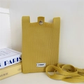 Close-up of vibrant yellow knitted crossbody phone bag with metal clasp and brand tag - Yellow