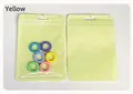 Translucent yellow resealable packaging bag with colorful rings inside on white background - Yellow