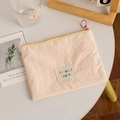 Pink fabric lipstick storage pouch with yellow zipper and colorful artistic label - White (Horizontal)