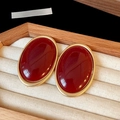 Detailed top view of red oval vintage earrings in a linen jewelry box display - 7# Gold Wine Red Oval (Silver Earring Post)