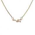 Detailed close-up of golden zodiac pendant necklace with sparkling cubic zirconia inlay - G-Taurus