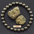 Natural golden pyrite beaded bracelet with raw pyrite stones on a slate background - Pyrite