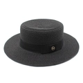 Detailed view of woven black straw boater hat with grosgrain ribbon and gold M badge - Black