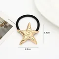 Detailed view of a gold starfish hair tie with dimensions 4.9cm by 5.4cm and weight 9g - Spiral Sea Star / Gold