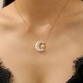 Close-up of star and moon pendant necklace with crystal inlay on black lace collar - Matte Silver Gold Sun Moon Rhinestone Style (6812)