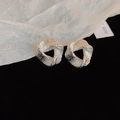 Detail of silver twisted geometric earrings with hammered irregular texture on dark velvet - Style 36# S925 Silver Pin Silver Geometric Triangle Studs