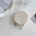 Detail of white lychee leather round coin purse with zipper and metal lobster clasp - Ivory