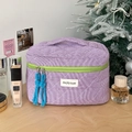 Close-up of quilted purple checkered makeup bag with green zipper and blue tassels - Large / Purple Plaid