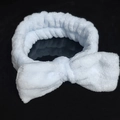 Light blue plush headband with bow design for skincare and makeup routines - Plush Bow Hairband / Light Blue