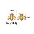 Detailed view of gold bee stud earrings with 8mm width and 6mm height dimensions - Gold Bee
