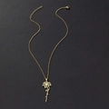 Close-up of golden stainless steel necklace with custom flower and script pendant - December Birth Flower (Poinsettia) / Gold
