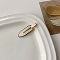 Detail of a beige cream hair clip with black piping on a white ceramic plate - 12# White Traceless Duckbill Clip