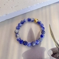Macro detail of 3mm blue marble natural stone beads and single gold accent on elastic ring - Elastic Free Size / White Blue Point