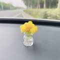 Miniature glass vase with yellow artificial flowers on car dashboard for good luck - Yellow Babysbreath