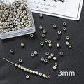 Vista detallada de cuentas de metal plateado de 3mm para creación de joyas DIY - Color Oro Blanco 3mm (100 piezas)
