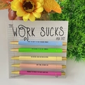 Five-piece colorful ballpoint pen set with funny quotes and gold metal trim - Work Sucks Theme
