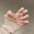 Detail of luxury champagne cat-eye press-on nails with 3D floral and rhinestone accents - By1712 Has Beautiful Features / Glue Type