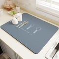 Macro detail of grey-blue kitchen drying mat with Love to Cook print and utensil graphics - Flavorful